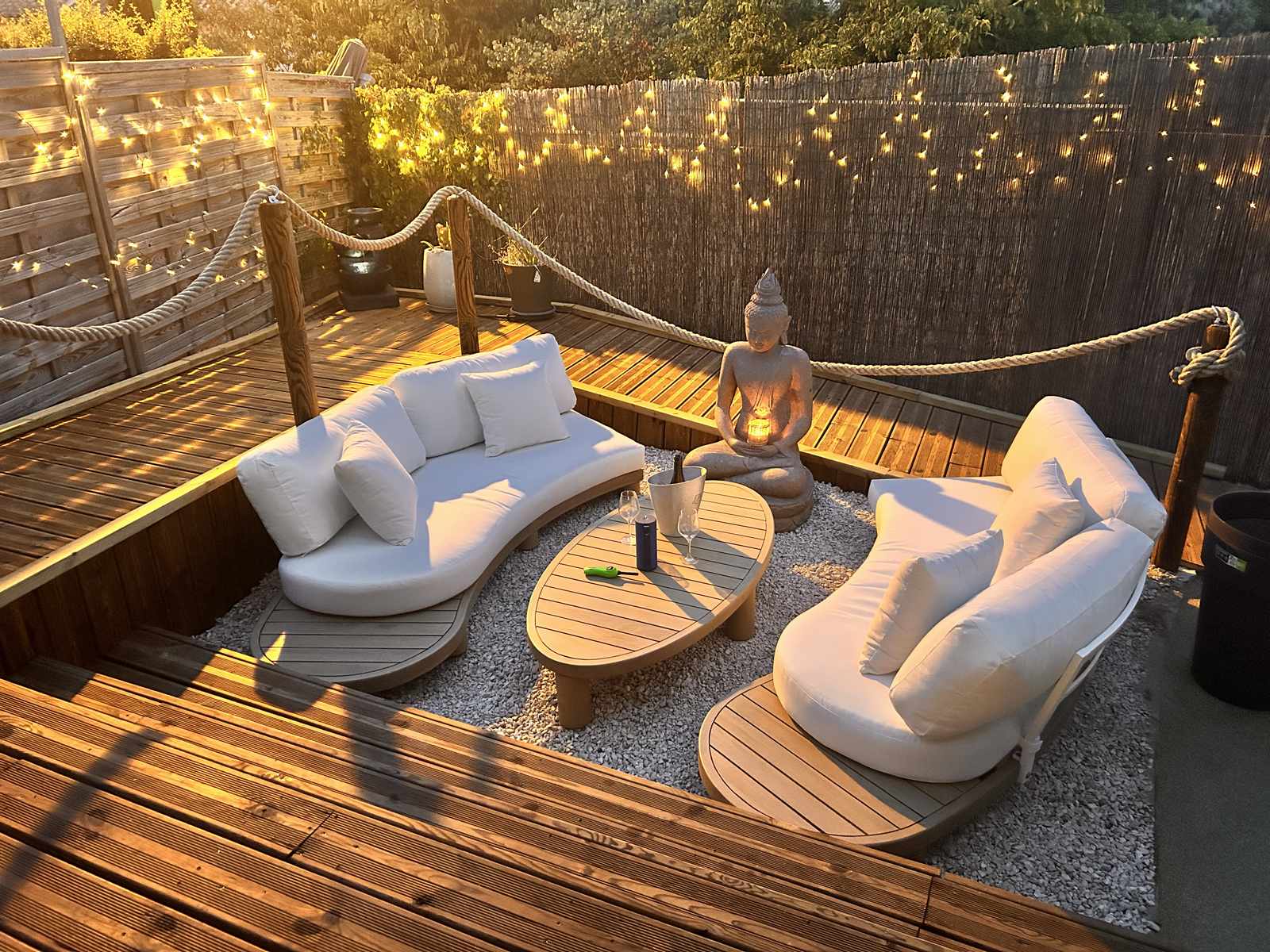 Le salon de la terrasse au soleil couchant, avec son Bouddha et ses guirlandes